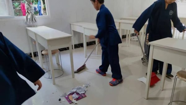 image shows students cleaning the classroom to learn Taoist culture and humility