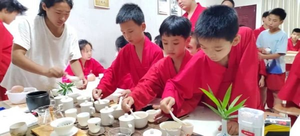 image shows young disciples learning tea culture during summer camp