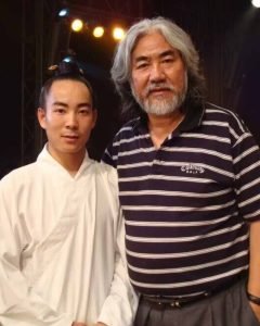image shows Chinese director Zhang Jizhong with wudang master qingfengzi